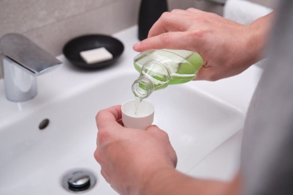 Man using mouthwash to combat bad breath 