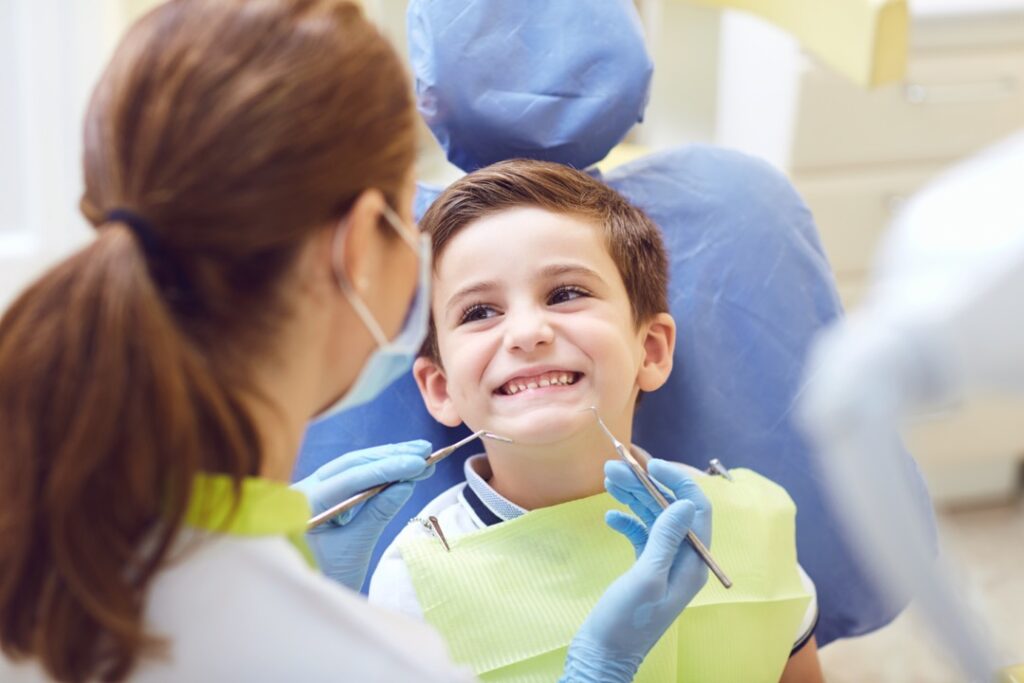 Young boy smiling at dentist 
