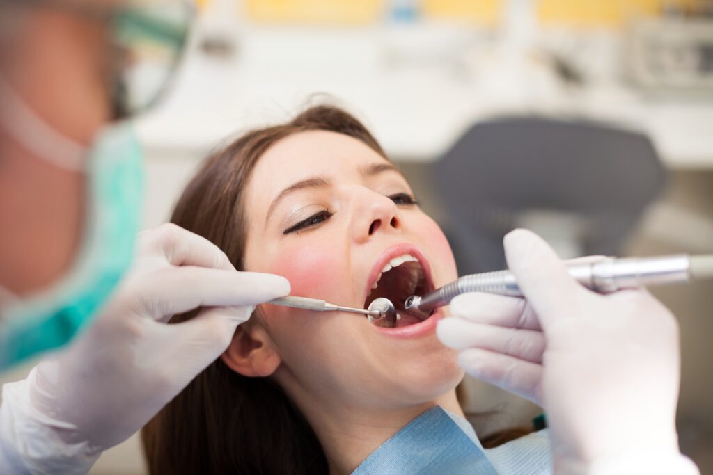 Dentist in Kelowna performing dental exam