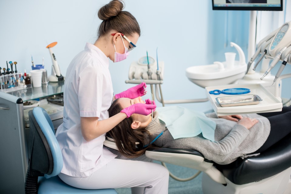 Dentist performing oral exam