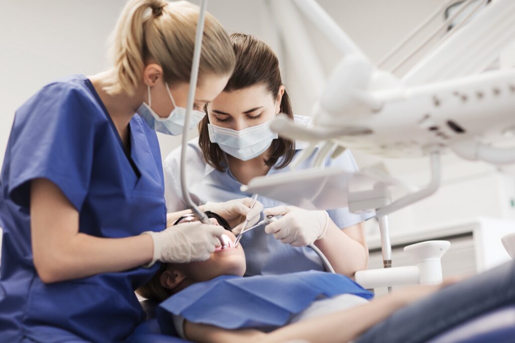 Hygienist helping patient with dental tooth decay
